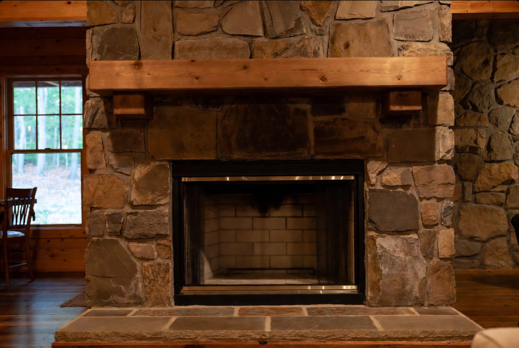 Fireplace remodel at a Nolin Lake cabin in Grayson County, KY — stone surround by Universal Interiors