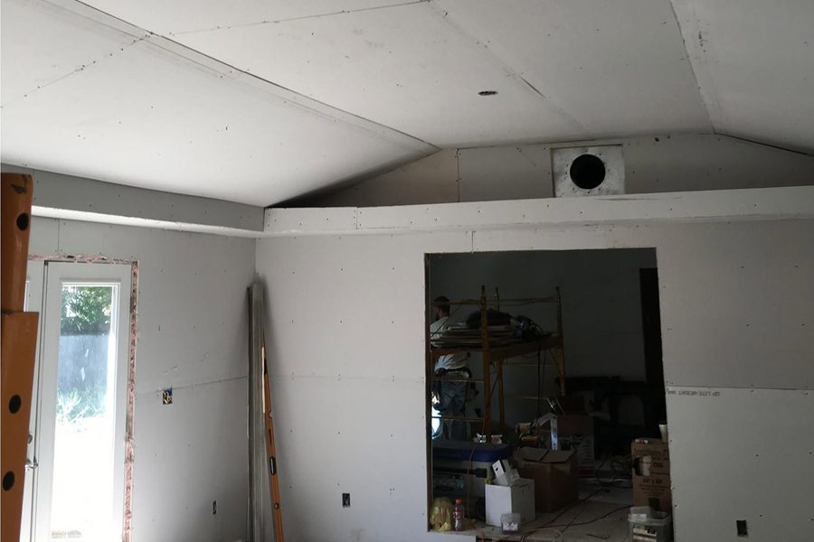 Room renovation in progress with new drywall hung on a vaulted ceiling and walls — western Kentucky